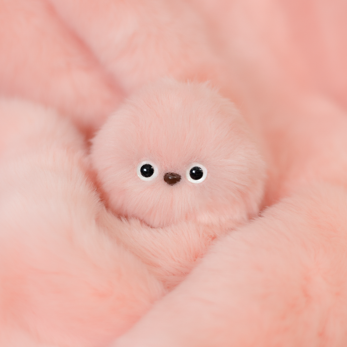 Mirumi bag charm robot in Pink. Features gentle, soft pink fluffy fur and two small eyes.